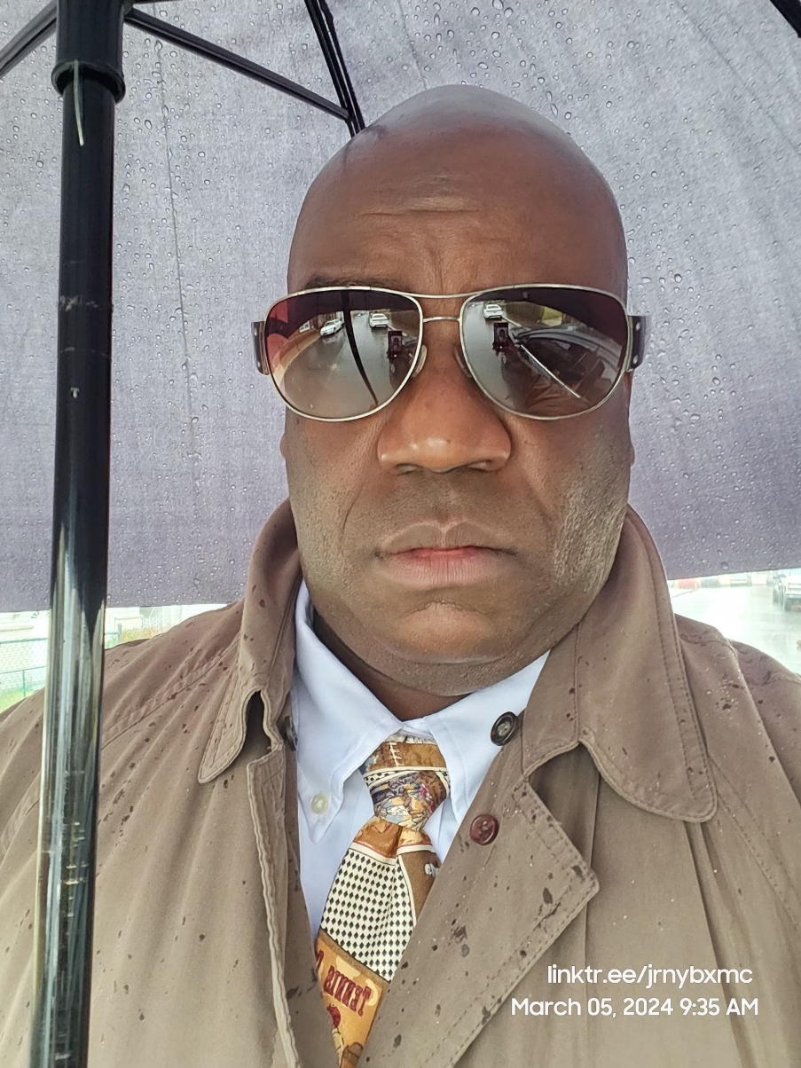 Portrait of the JRNY BXMC host under an umbrella
